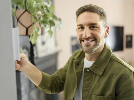 Smiling man who adjust his central heating system.
